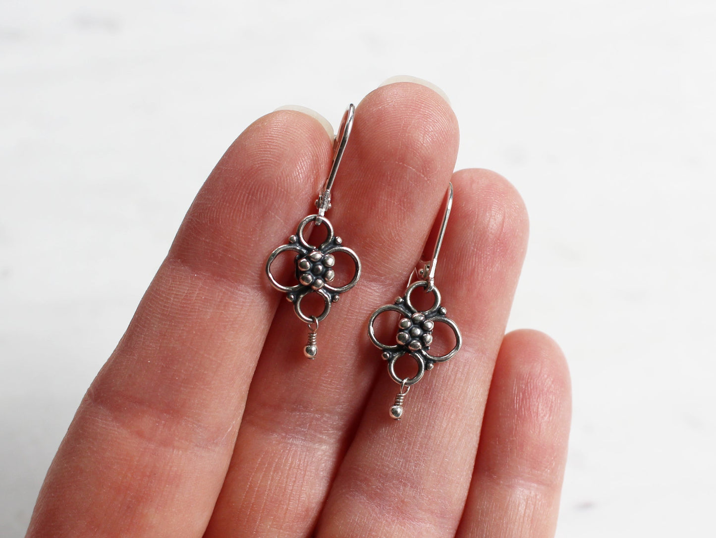 silver quatrefoil flower earrings on lever back ear wires