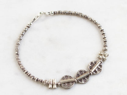Silver beaded bracelet on a white background