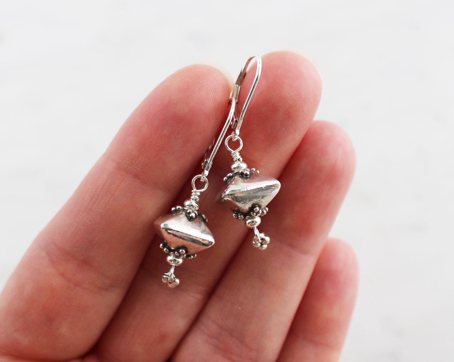 Bali sterling silver geometric dangle earrings on lever backs.