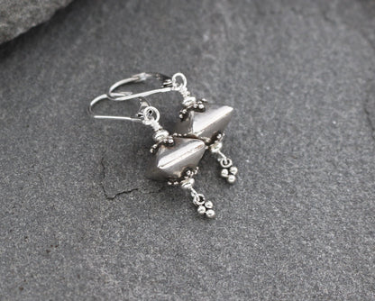 Bali sterling silver geometric dangle earrings on lever backs ear wires.